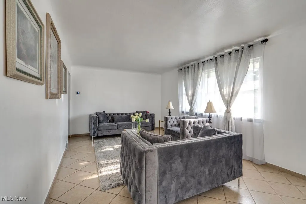 Living area featuring light tile patterned floors