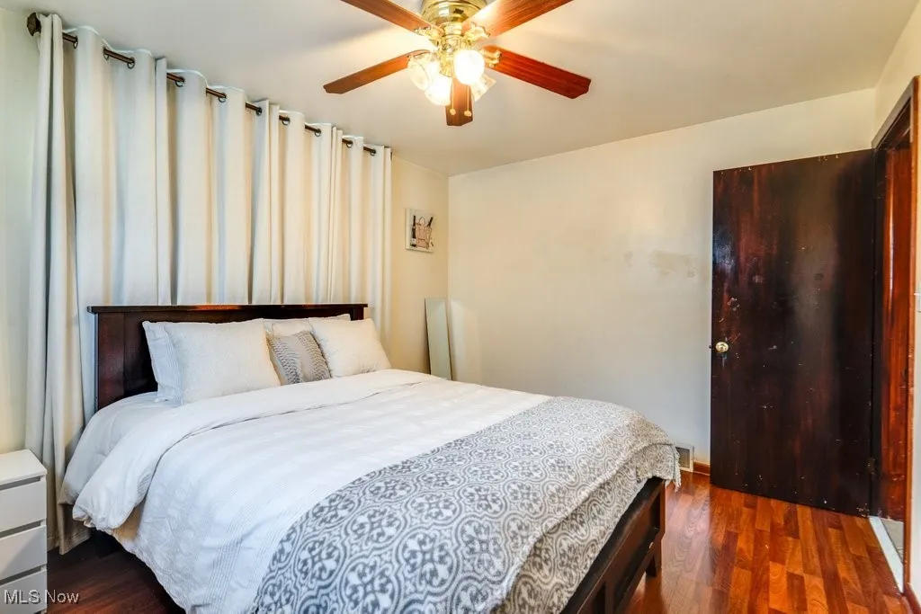 Bedroom featuring dark wood-type flooring and a ceiling fan