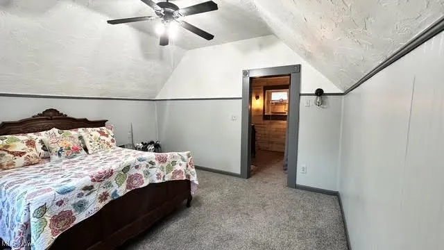 Second floor Bedroom with carpet, a textured ceiling, lofted ceiling, and ceiling fan