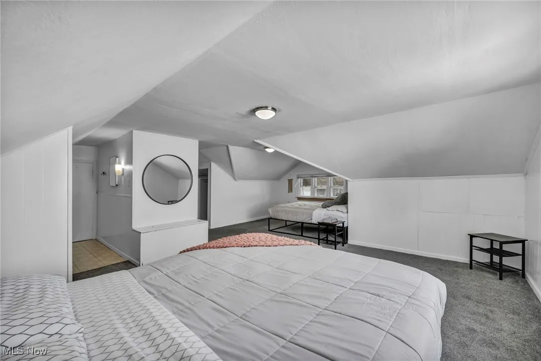 Bedroom featuring vaulted ceiling and carpet flooring