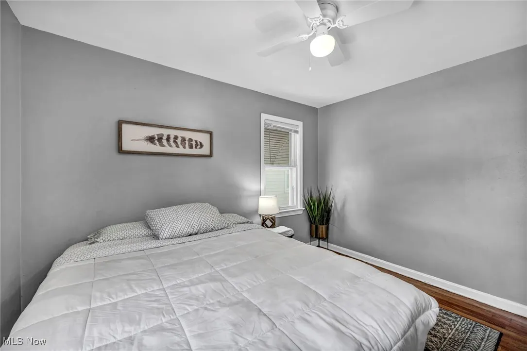 Bedroom with wood finished floors and ceiling fan