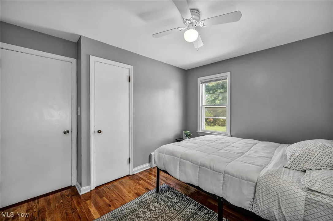 Bedroom with wood finished floors and a ceiling fan
