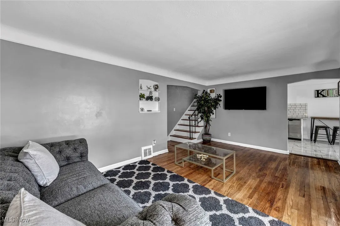 Living area featuring wood-type flooring and stairs
