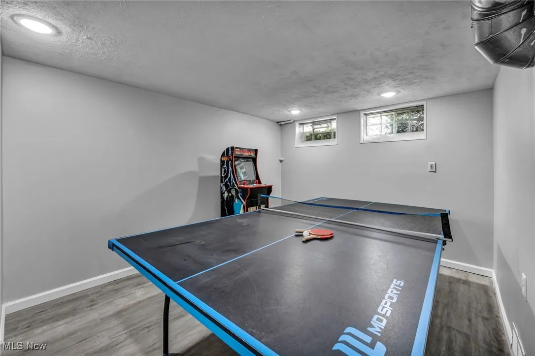 Rec room with recessed lighting, wood finished floors, and a textured ceiling