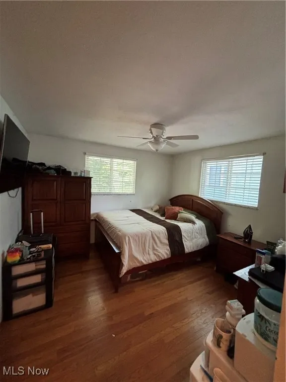Bedroom featuring dark wood finished floors and a ceiling fan