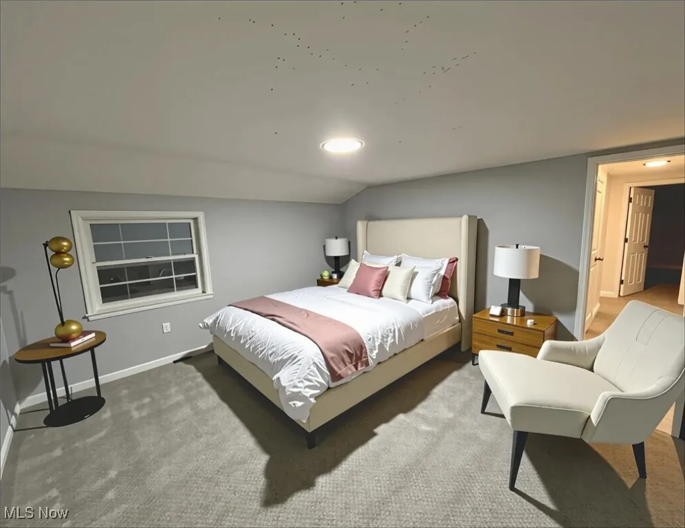 Bedroom featuring vaulted ceiling and carpet flooring