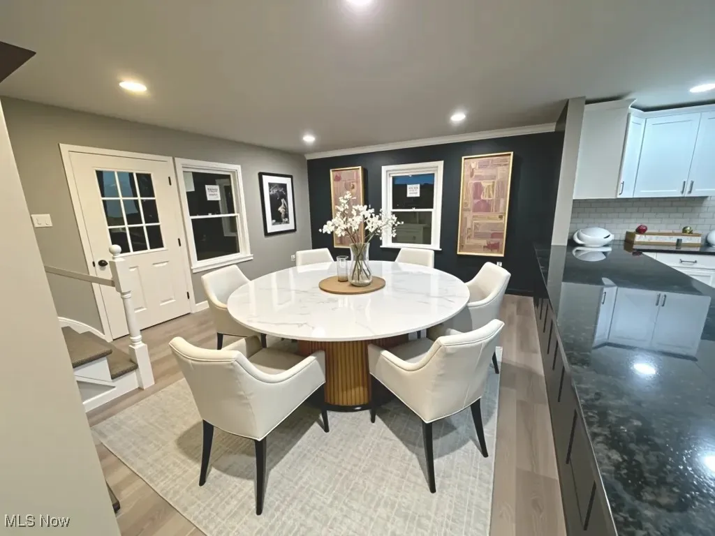 Dining space with recessed lighting, light wood-style flooring, and crown molding