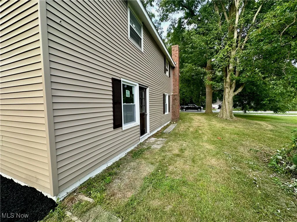 View of home's exterior with a yard