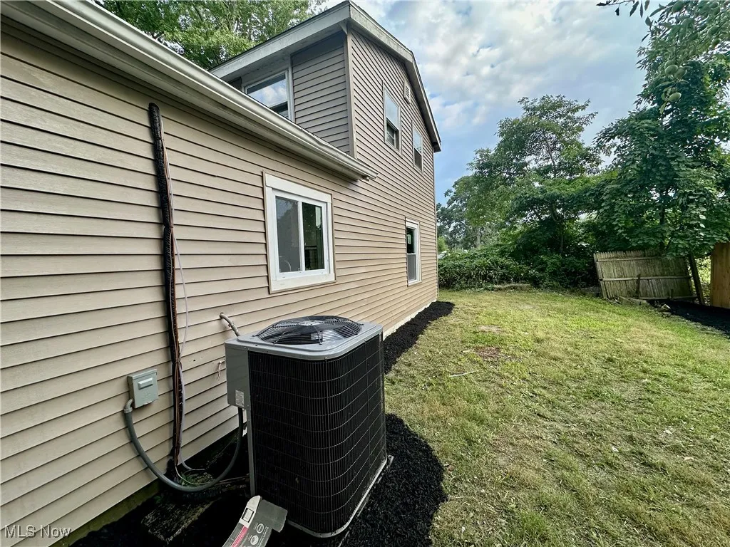 View of side of property featuring a central AC unit