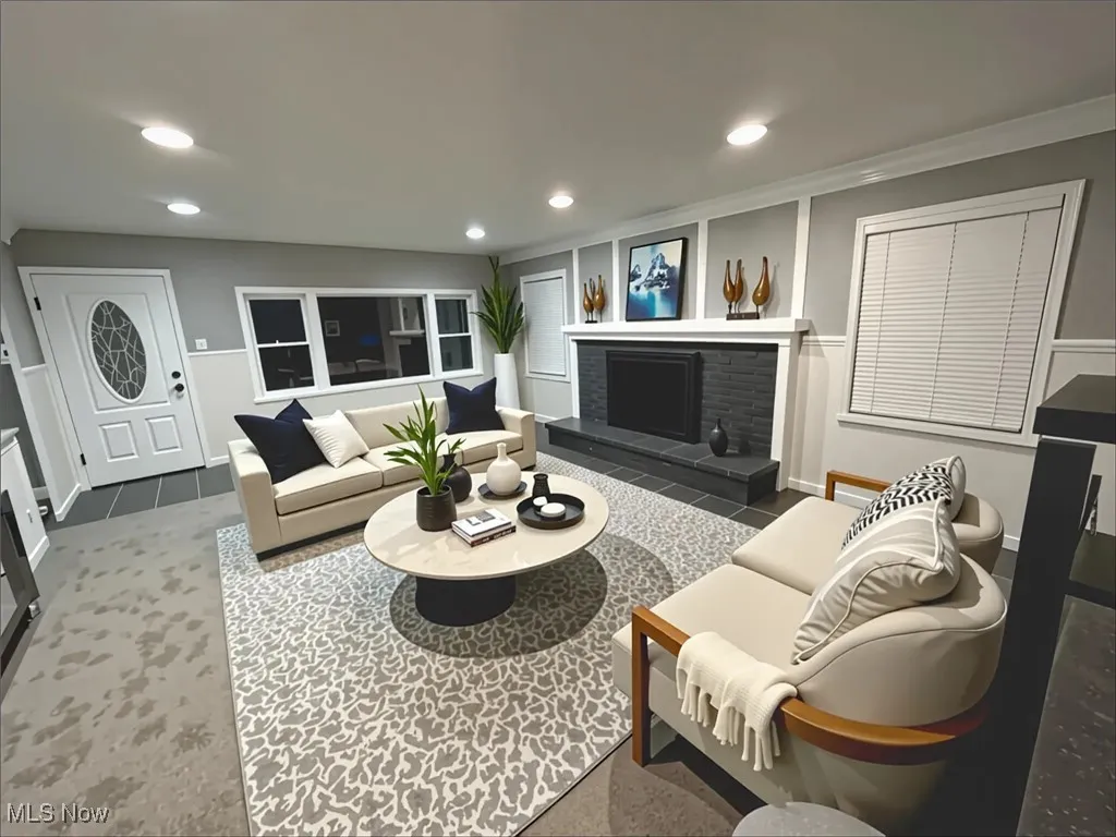 Living room featuring recessed lighting, a brick fireplace, and crown molding