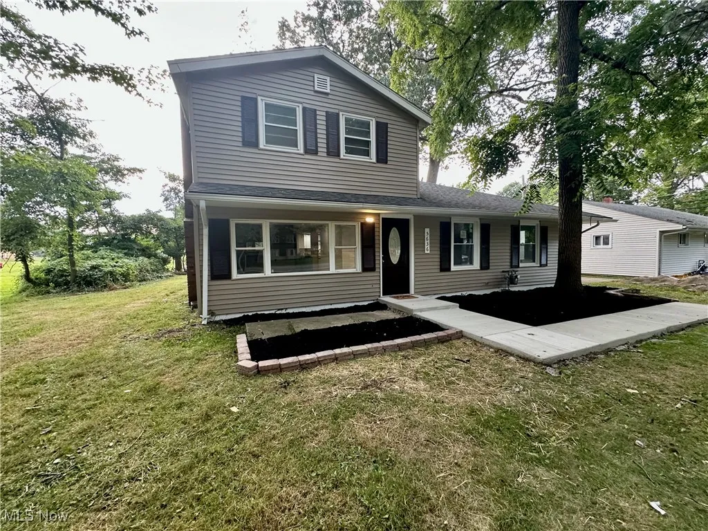 Traditional-style home with a front lawn
