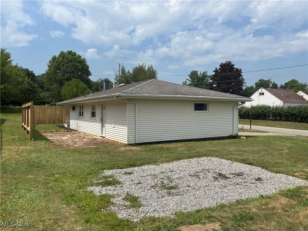 View of side of property featuring roof with shingles