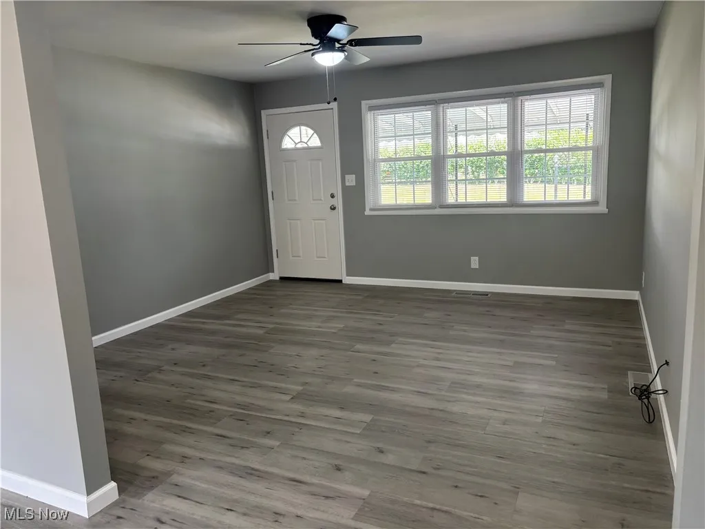Foyer entrance featuring a ceiling fan and wood finished floors