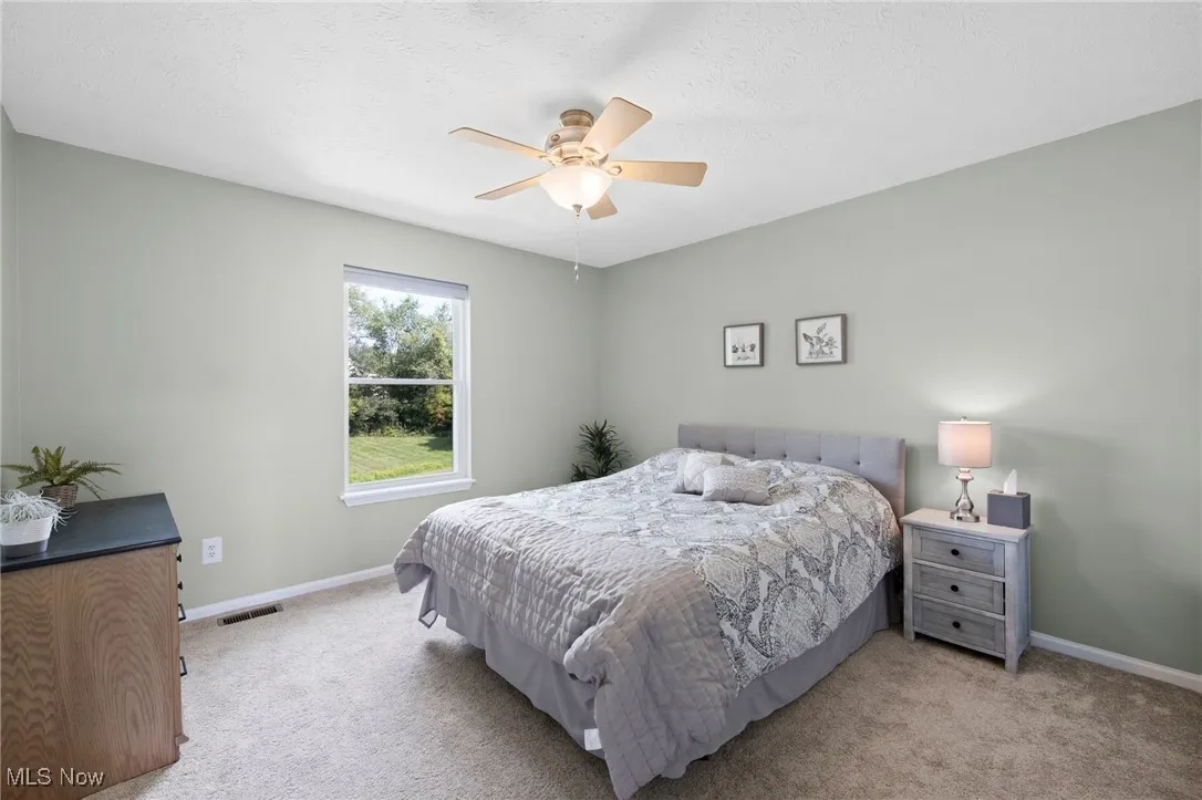 Bedroom #2 Carpeted with a ceiling fan