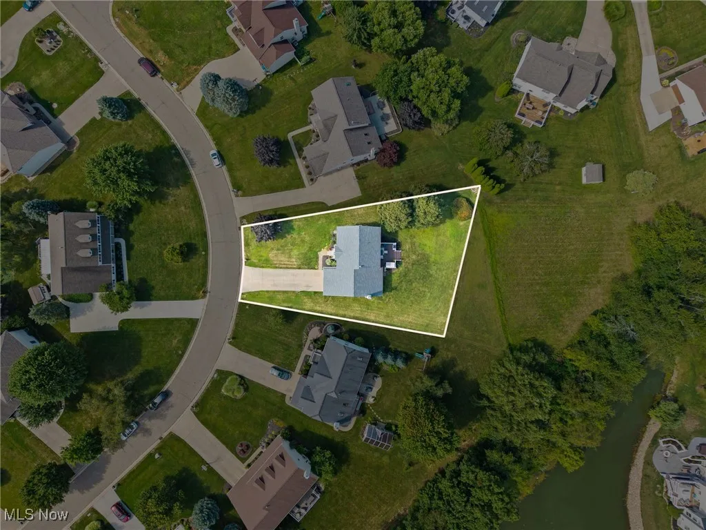 Aerial view of property's location featuring property parcel outlined and nearby suburban area