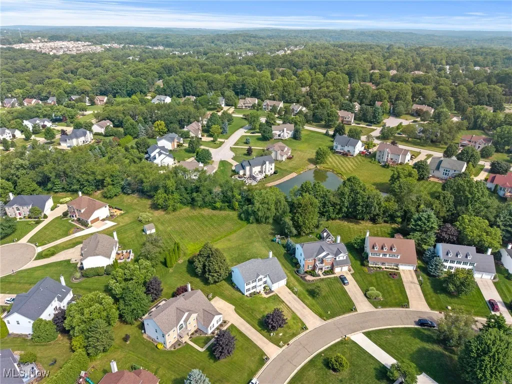 Aerial overview of property's location featuring nearby suburban area and a nearby body of water