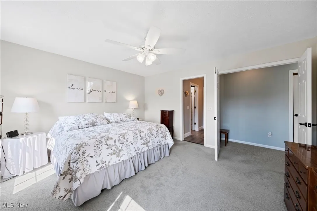 Bedroom featuring light colored carpet and a ceiling fan