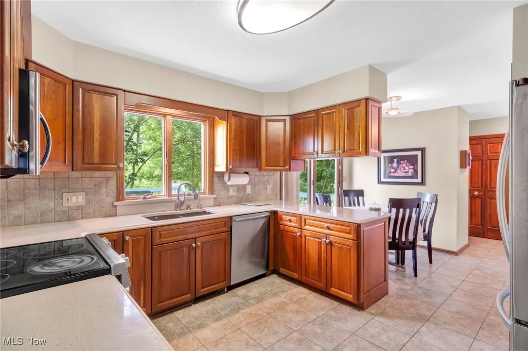 Warm and welcoming Kitchen with abundant cherry cabinetry for generous storage.