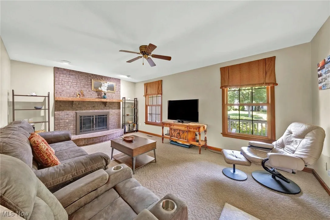 Family Room features floor-to- ceiling, brick fireplace with raised hearth.