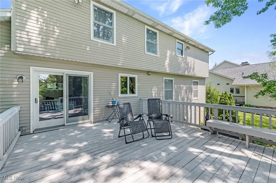 Oversized Deck features steps leading down to brick patio