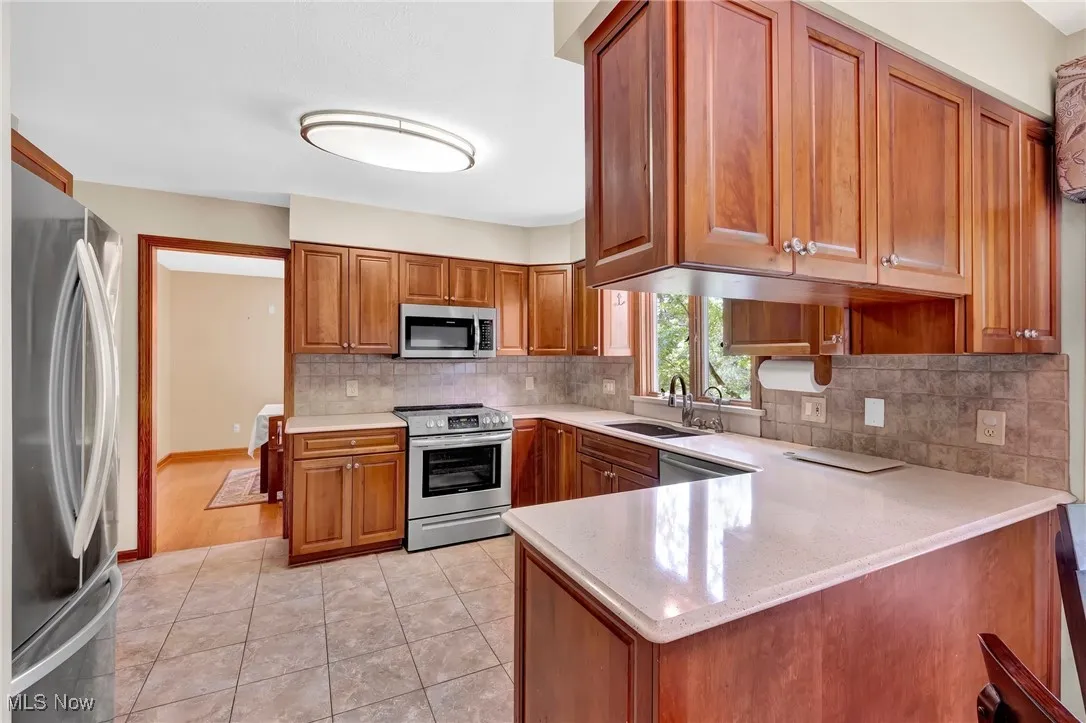 Kitchen features Cambria quartz counters, stone backsplash and Blanco undemount sink.