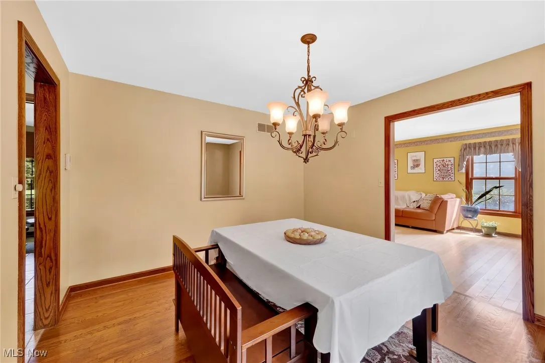A lovely chandelier anchors the Dining Room