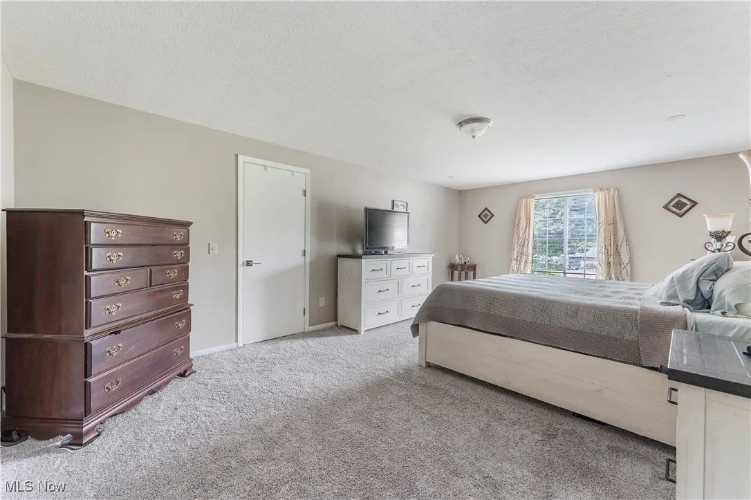 Bedroom featuring a textured ceiling and carpet