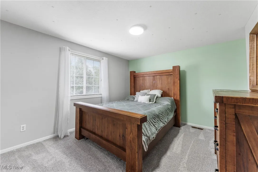 Carpeted bedroom featuring baseboards