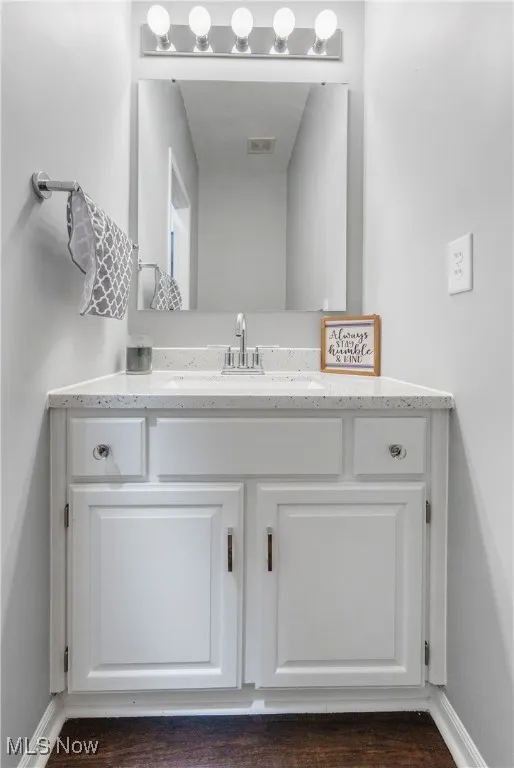 Bathroom with vanity and wood finished floors
