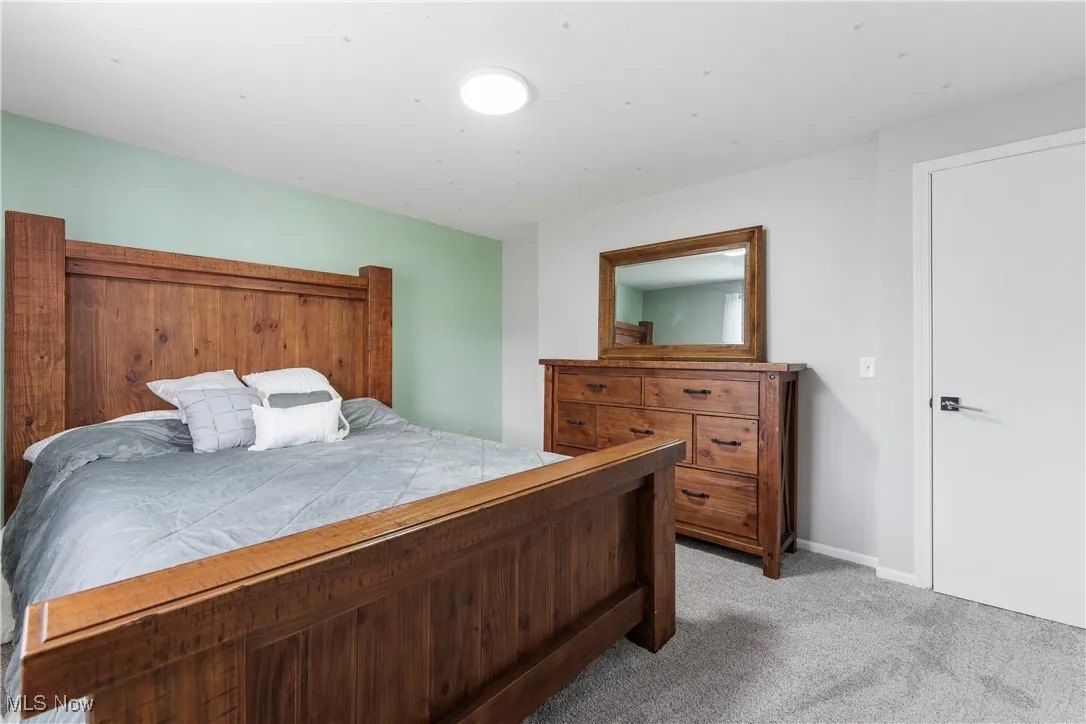 Bedroom with light carpet and baseboards