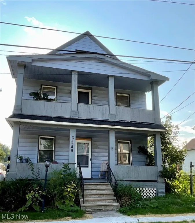 View of front of home with a balcony and covered porch