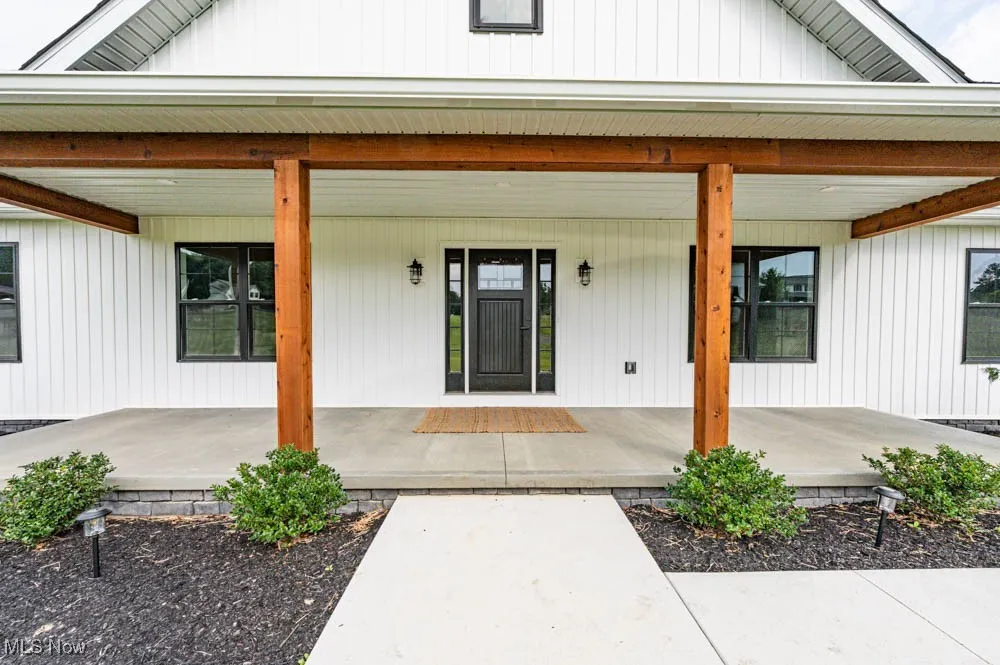Doorway to property with covered porch