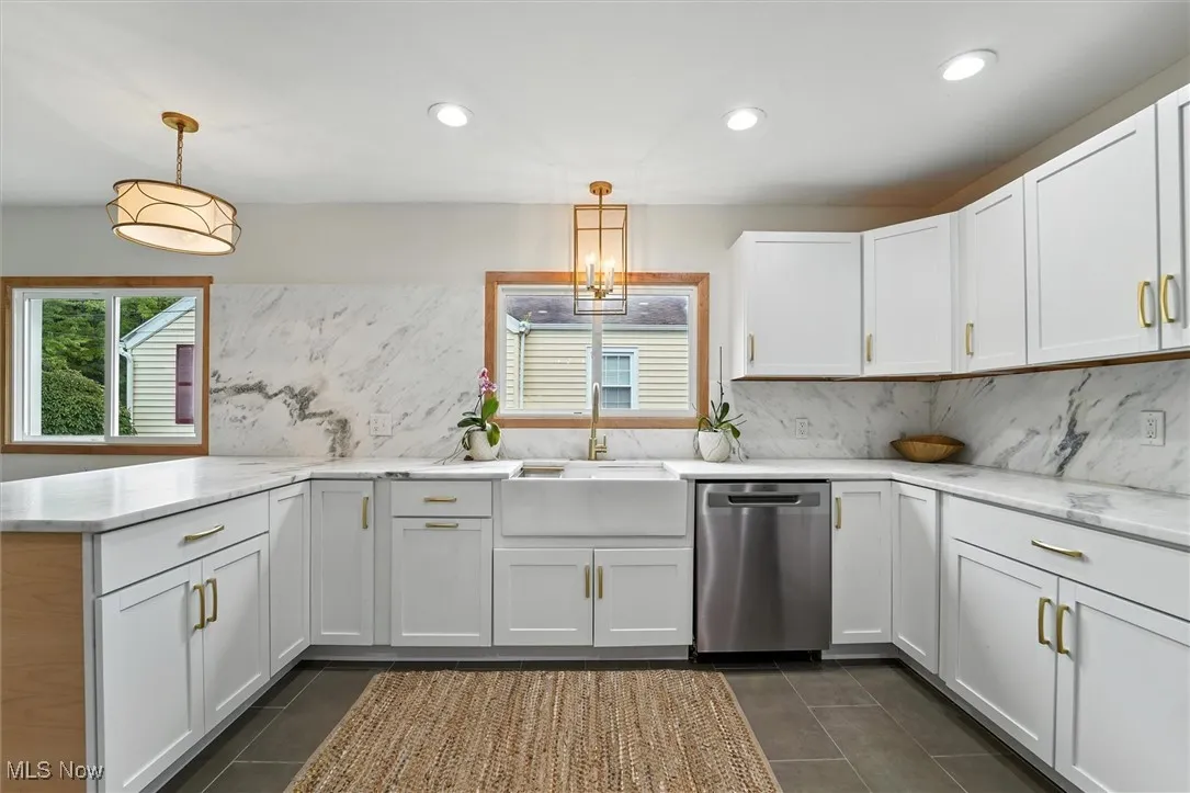Kitchen featuring decorative backsplash, stainless steel dishwasher, recessed lighting, white cabinetry, and a peninsula