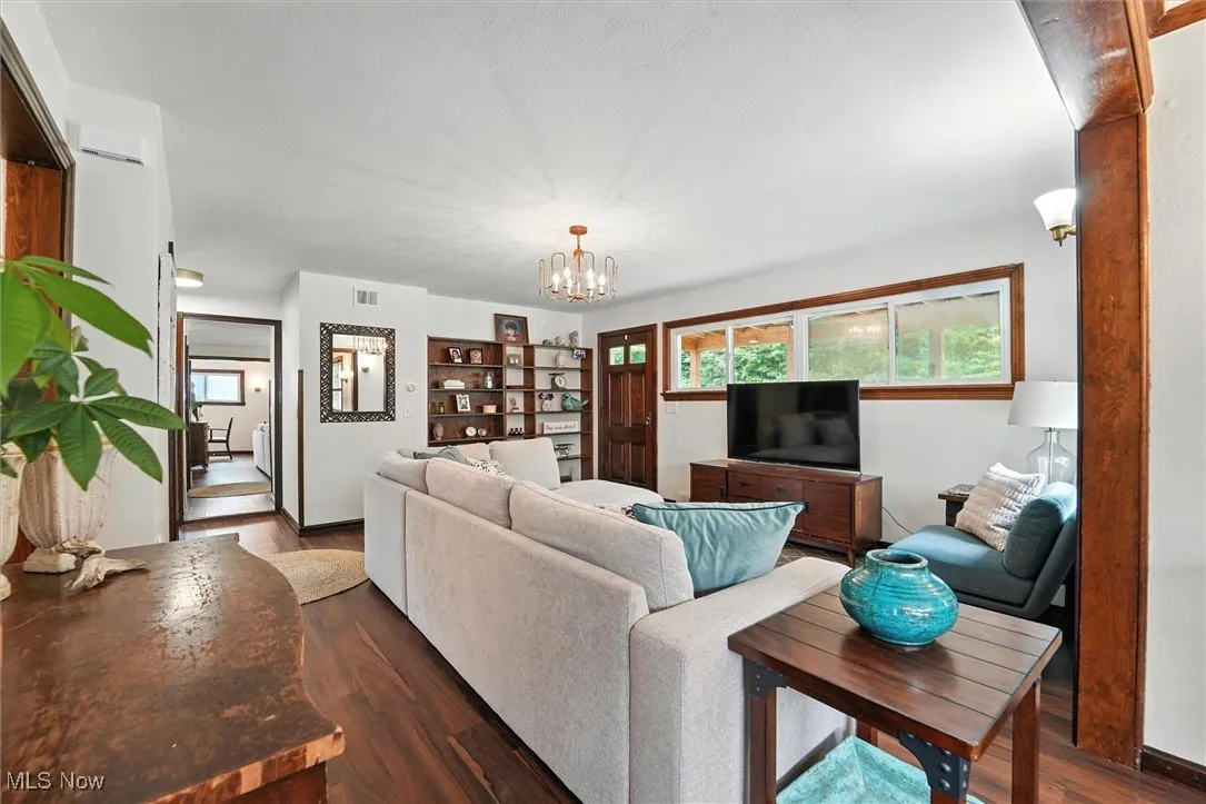 Living area featuring wood finished floors and a chandelier