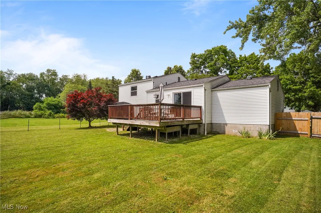 Back of property featuring a wooden deck