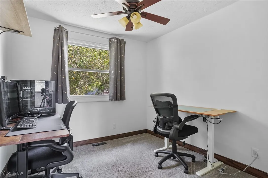 3rd bedroom/office featuring a ceiling fan and carpet floors