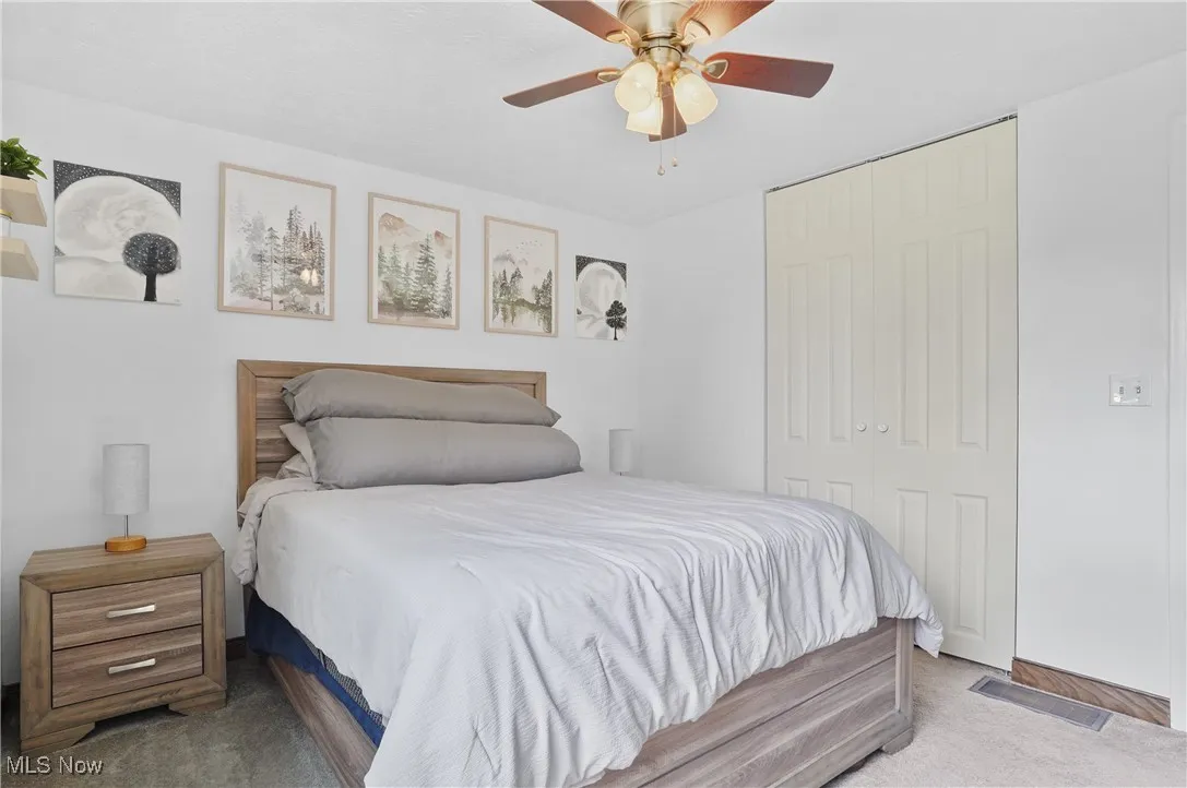Primary Bedroom with carpet floors, a closet, and ceiling fan