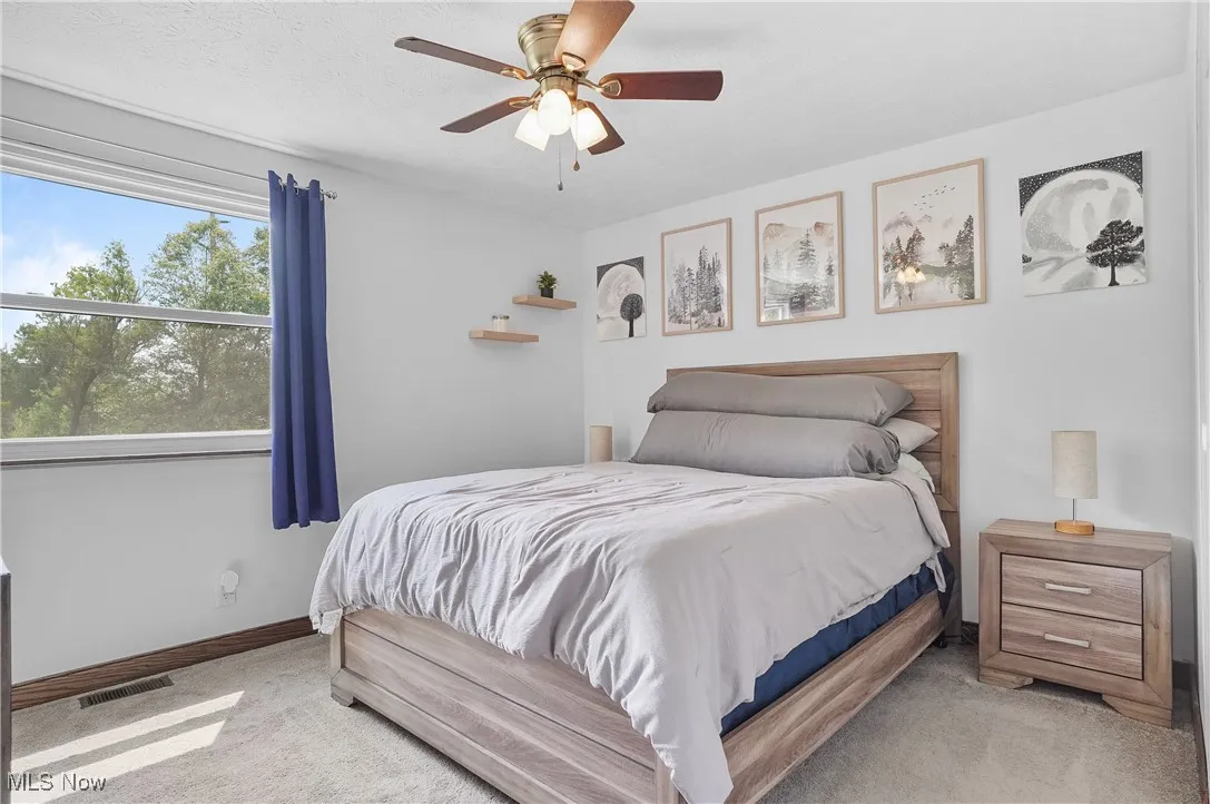 Primary Bedroom featuring carpet floors and ceiling fan