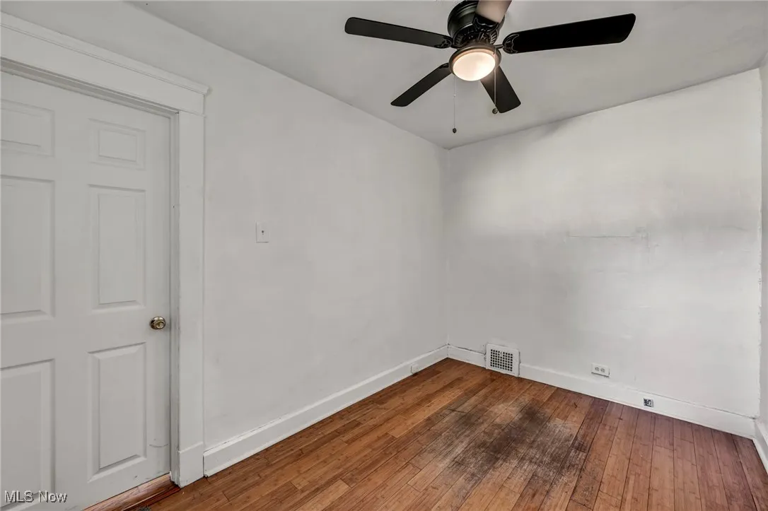 Unfurnished room featuring hardwood / wood-style flooring and ceiling fan