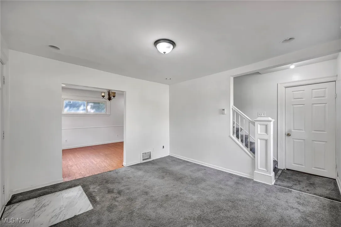 Spare room with carpet and stairway