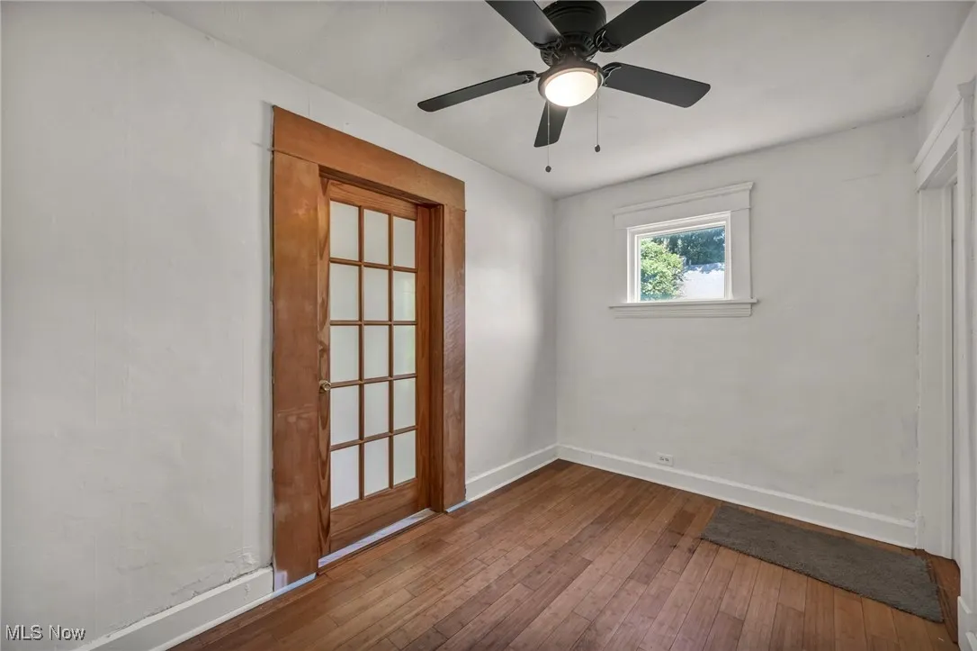 Spare room with hardwood / wood-style flooring and ceiling fan