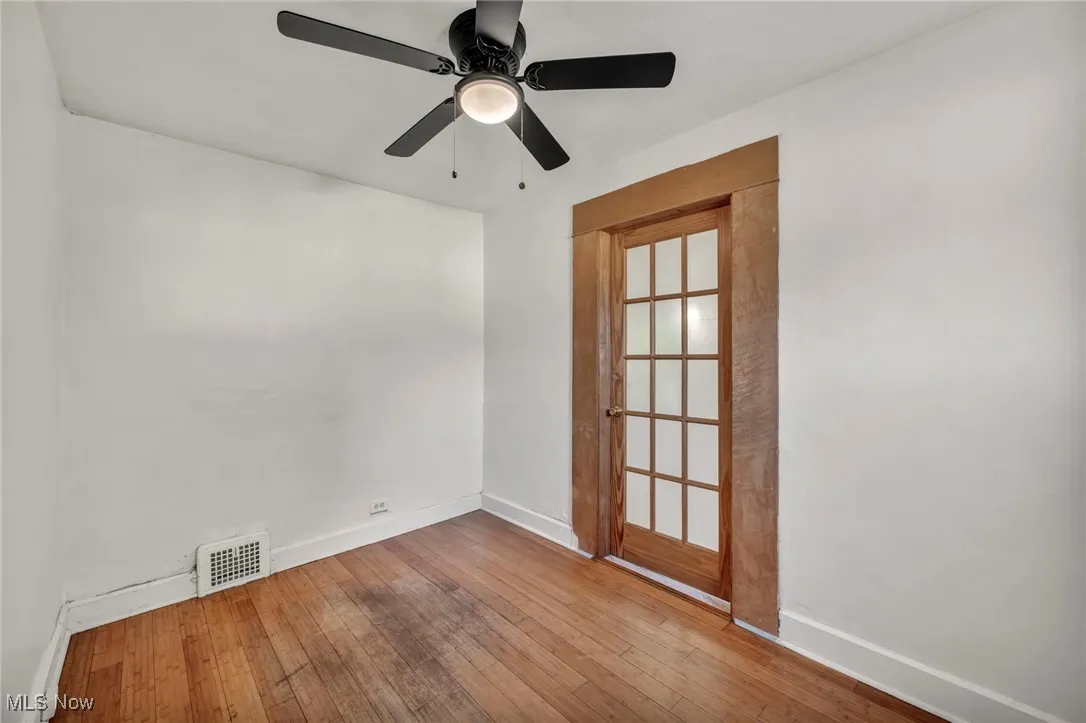 Spare room with hardwood / wood-style flooring and a ceiling fan