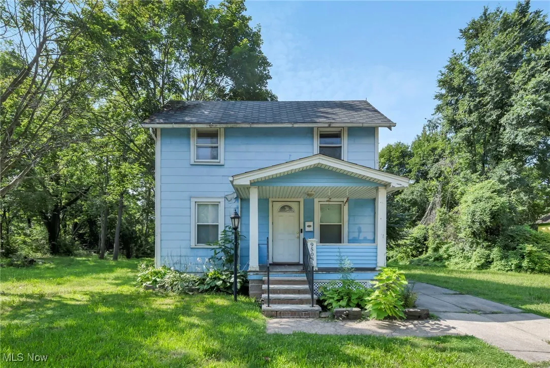 View of front of home featuring covered porch and a front lawn
