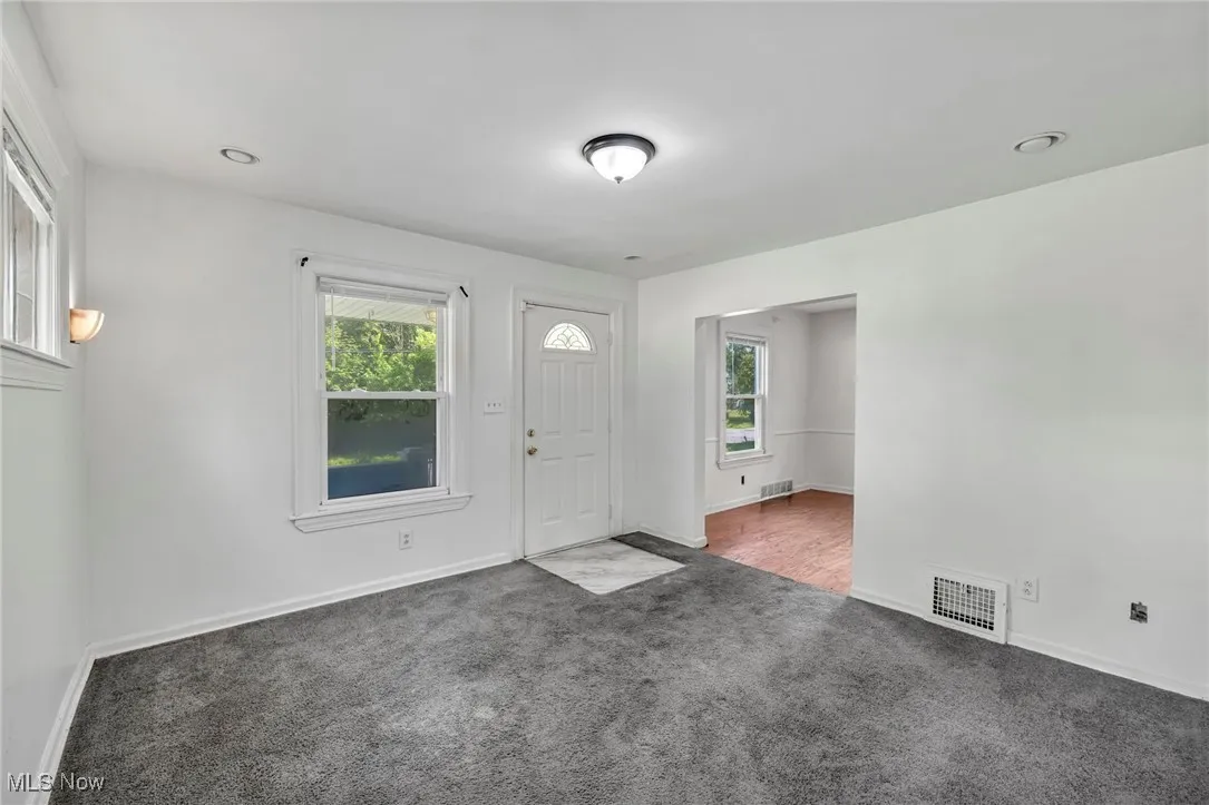 Carpeted entrance foyer featuring healthy amount of natural light and recessed lighting