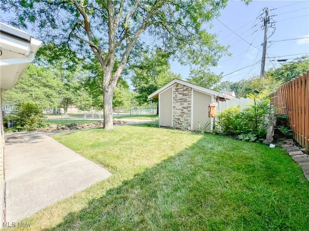 Fenced backyard with a shed