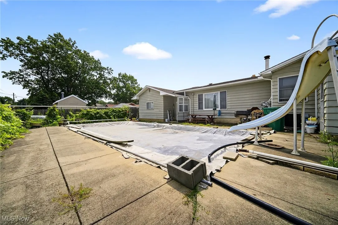 Back of property with 36x18 built in pool that is 3.5 ft deep with cover.