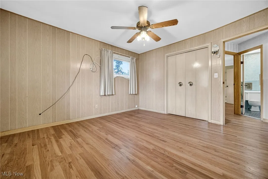 Bedroom featuring wood finished floors, a closet, and ceiling fan