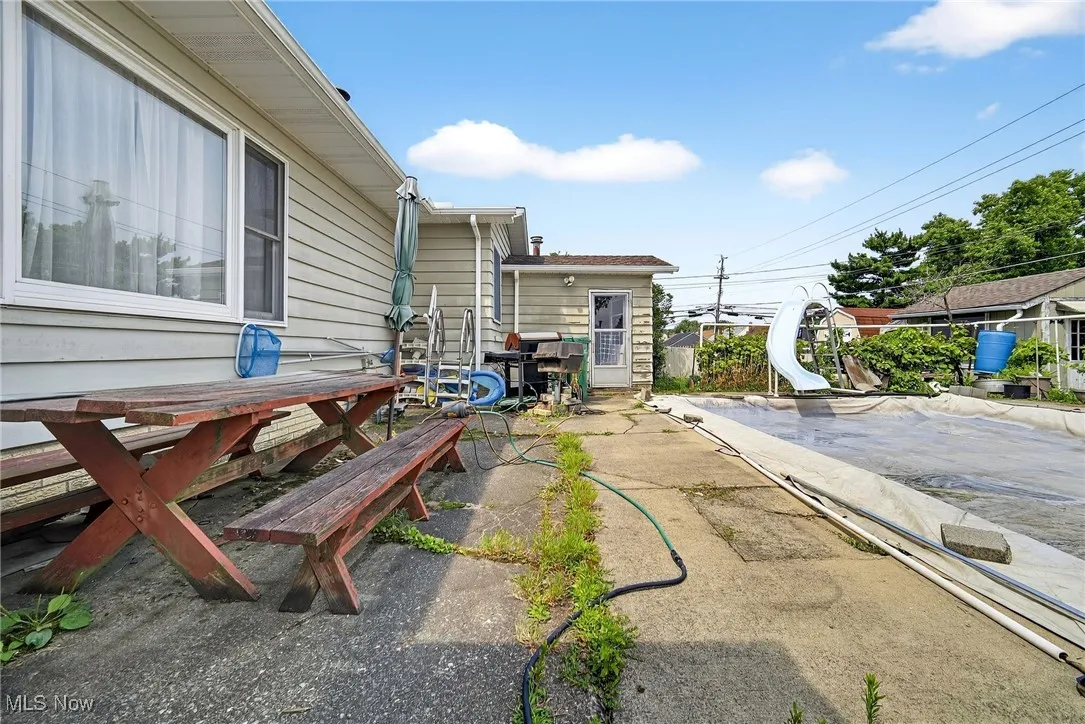 View of yard with a patio, 36x18 built in pool that is 3.5 ft deep with cover.