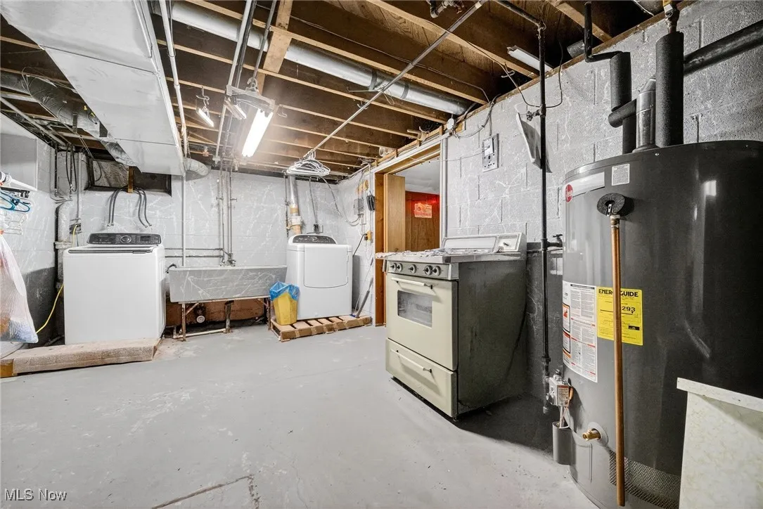 Basement with gas water heater and separate washer and dryer