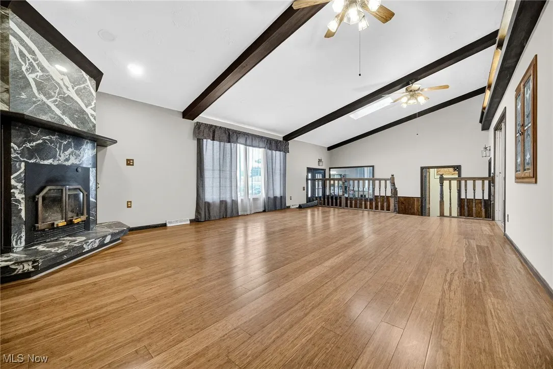 Great Room with cathedral ceilings,  bamboo wood finished floors and a high end marble fireplace that has a 65% high efficiency  wood burning insert.